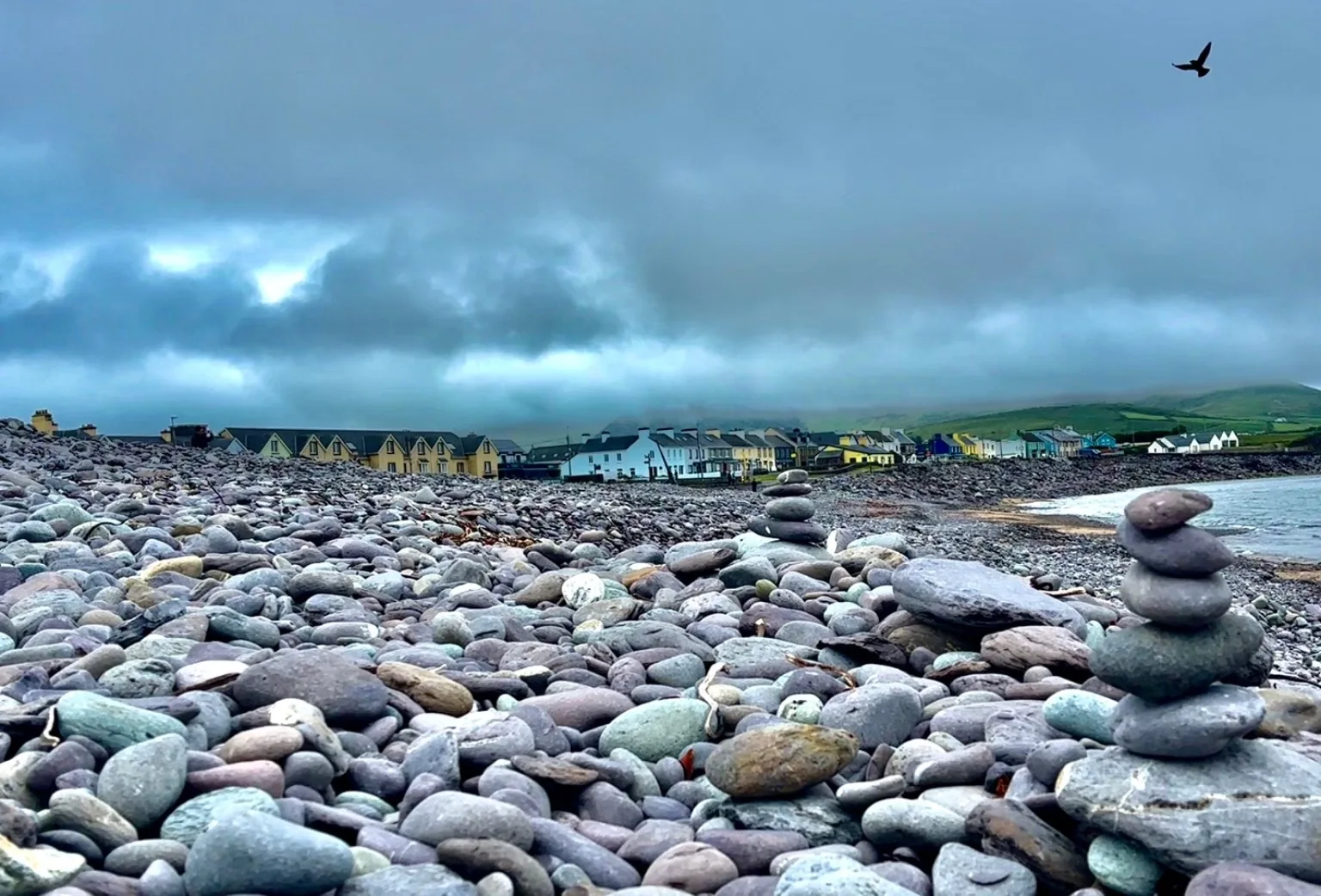 Balanced stone stacks on a rocky beach