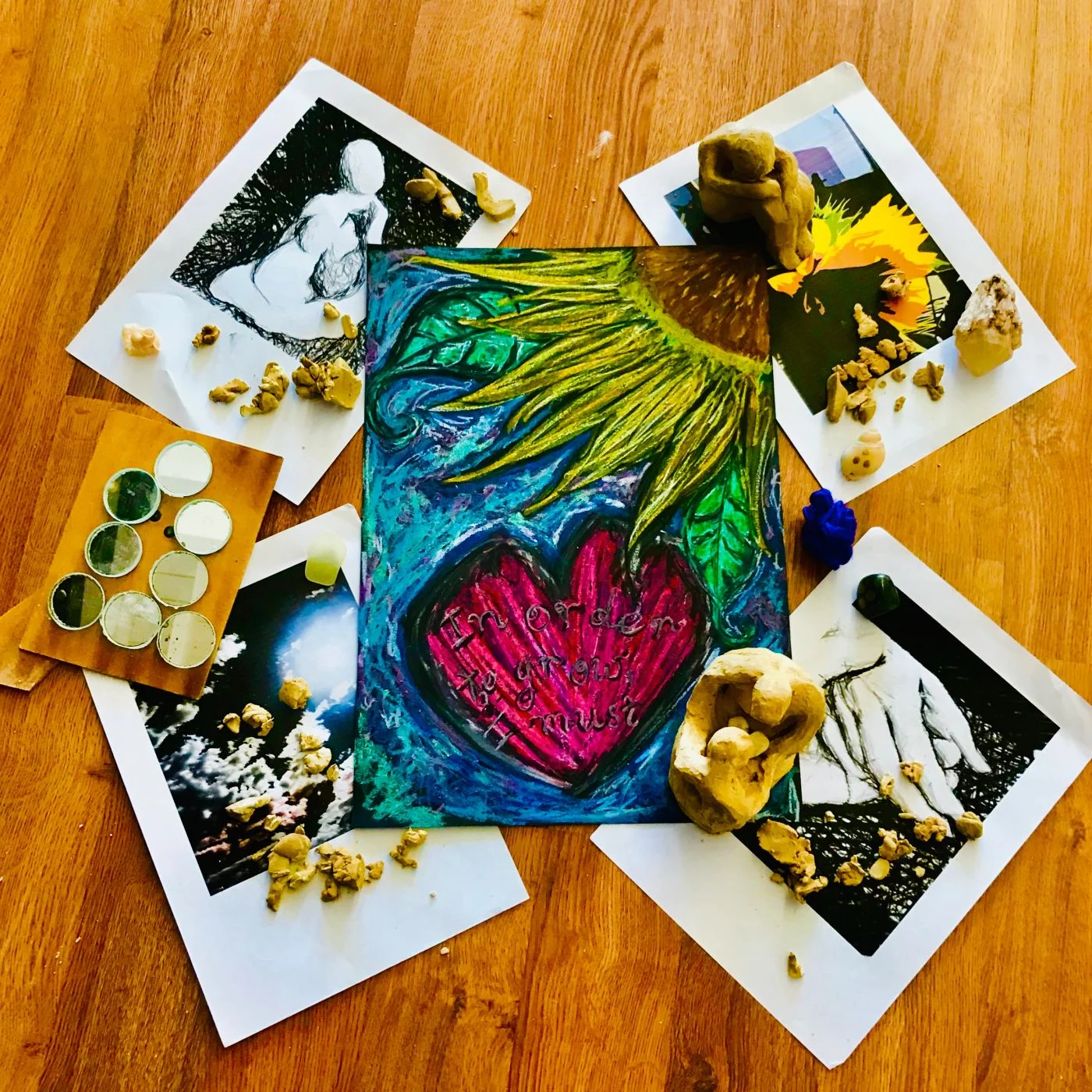 Paint, handmade artwork and creative materials arranged on a studio table