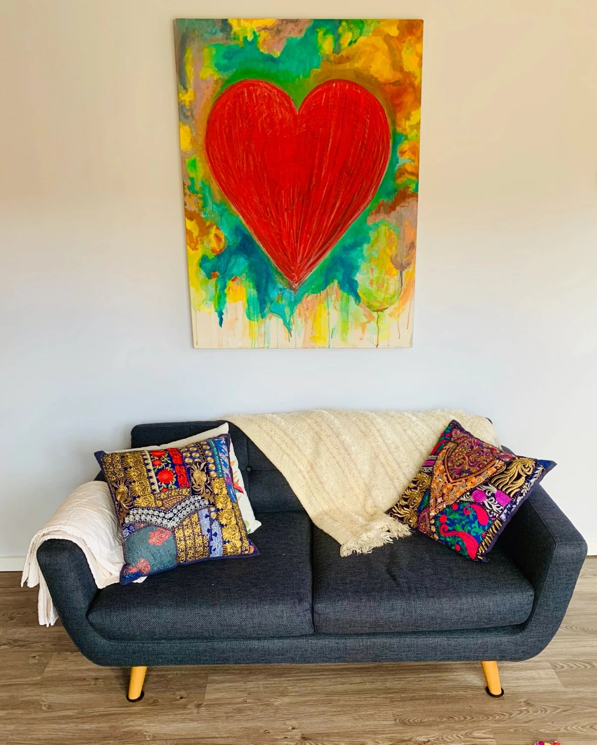 Comfortable therapy seating beneath a colourful heart artwork
