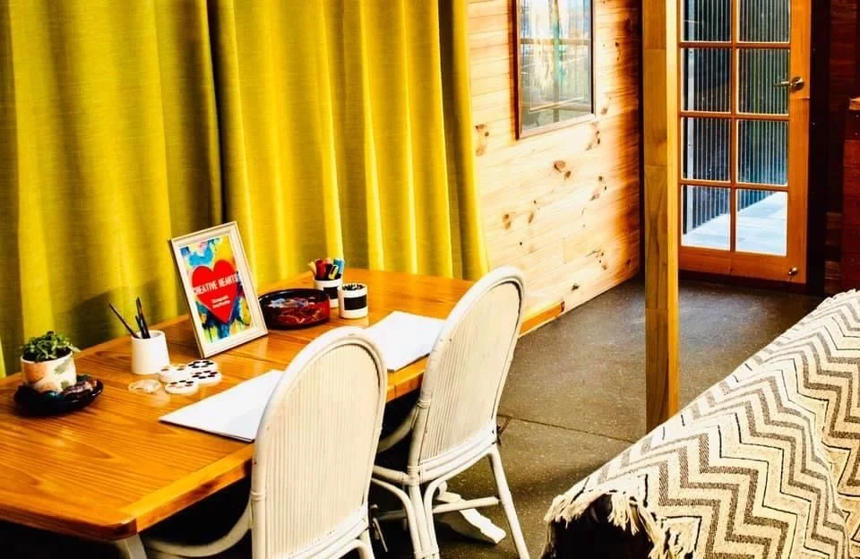 A bright table and chairs by the studio window